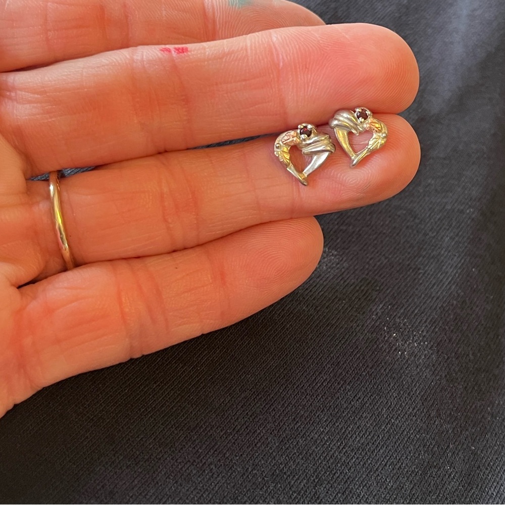 Sterling silver heart shaped stud earrings with Black Hills gold and garnet.